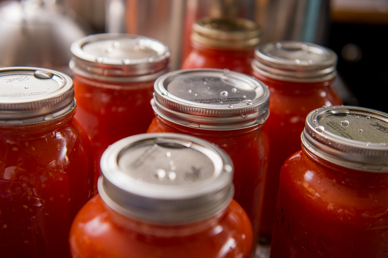 Image of canned tomatoes right out of a water bath canner.