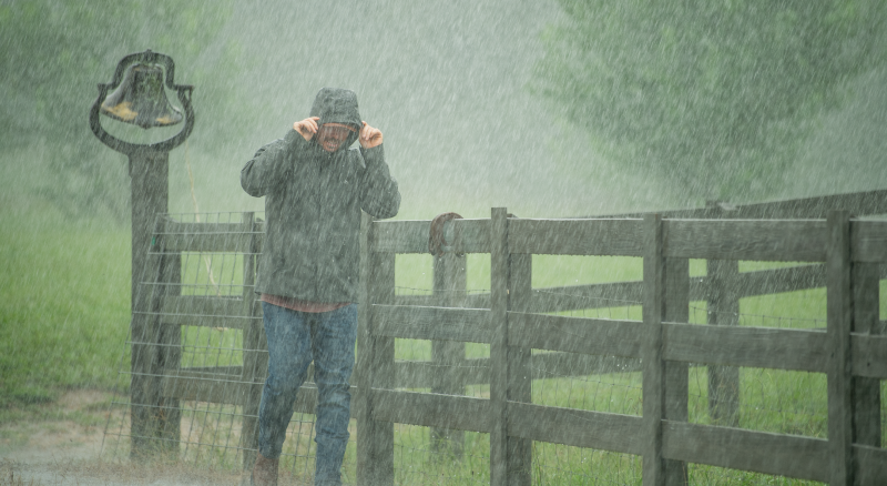 Man walking in heavy rain