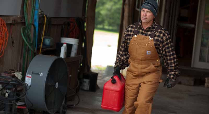 Man carrying a gas can preparing for an emergency